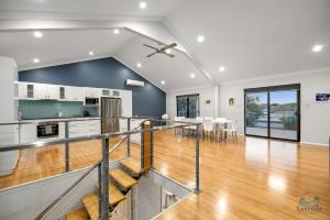 a kitchen and dining room with a staircase in a house at Dune View in Lancelin