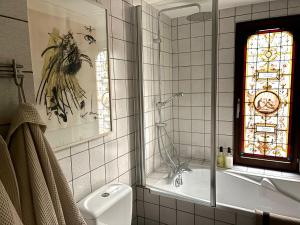 a bathroom with a shower and a toilet and a window at Cozy house in Olmen in Balen +30 photos