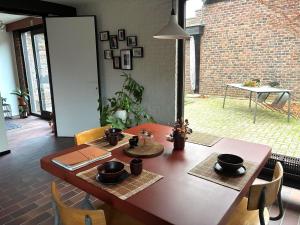 a dining room table with chairs and a dining room at Cozy house in Olmen in Balen