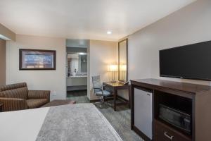 a hotel room with a large flat screen tv at SureStay by Best Western Salt Lake City Downtown in Salt Lake City