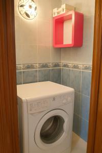 a washing machine in a bathroom with a red box at Apartment Rue Kifa Meknes in Meknès +3 photos
