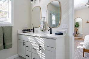 a bathroom with a sink and two mirrors at Casa Verde in Durham +58 photos