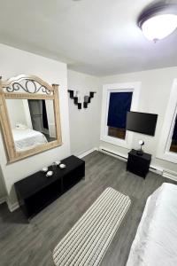 a bedroom with a bed and a large mirror at Bright Private Room Shared Bathroom in Elizabeth