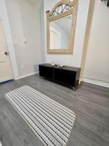a bathroom with a mirror and a rug on the floor at Bright Private Room Shared Bathroom in Elizabeth +5 photos