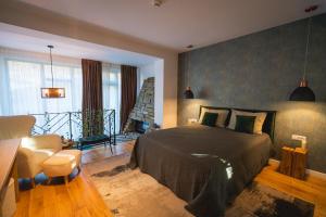 a bedroom with a bed and a table and chairs at Mosia Vasiloaica in Pleaşa +53 photos