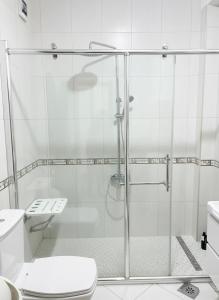 a bathroom with a glass shower with a toilet at Ahmet Pasha apartments ne qender te Pejes me nji dhom te fjetjes e sallon qe i ka dy shtreter in Peje +9 photos