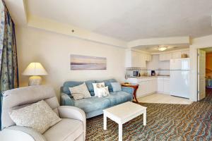 a living room with a couch and a kitchen at Daytona Beach Resort 533- Oceanfront Oasis in Daytona Beach