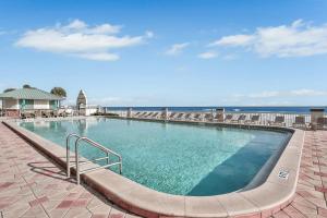 a large swimming pool with the ocean in the background at Daytona Beach Resort 533- Oceanfront Oasis in Daytona Beach