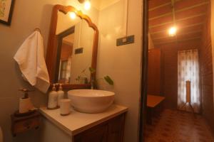 a bathroom with a sink and a mirror at Green Roots Farm Stay, Shahapur in Shāhāpur +51 photos