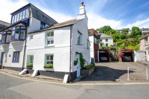 een wit huis met een toren op een straat bij 2 Bed in West Looe oc-l30054 in Looe