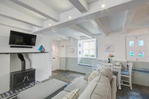 een woonkamer met een bank en een open haard bij 2 Bed in West Looe oc-l30054 in Looe