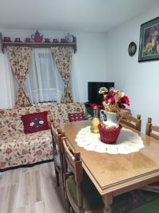 a living room with a table and a couch at Brvnara Zlatni mir in Vodice