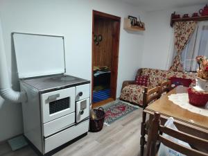 a living room with a stove and a table at Brvnara Zlatni mir in Vodice