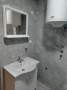 a bathroom with a white sink and a mirror at Brvnara Zlatni mir in Vodice +16 photos