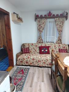 a living room with a couch and a table at Brvnara Zlatni mir in Vodice