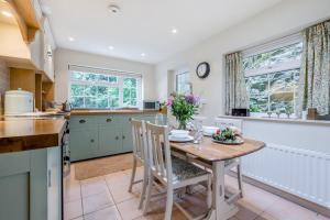a kitchen with a table with flowers on it at 2 Bed in Looe oc-l30015 in Lansallos