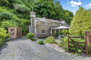 an old stone house with a garden and a fence at 2 Bed in Looe oc-l30015 in Lansallos