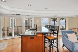 a kitchen and living room with a view of the ocean at Shiphouse 1 - First Floor in East End