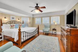 a bedroom with a bed and a flat screen tv at Shiphouse 1 - First Floor in East End +62 photos