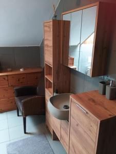 a bathroom with a sink and a cabinet with a mirror at Chalet Sedmihori in Staré Sedlo +9 photos