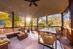 a screened in porch with a couch and a table at Casa Verde in Durham