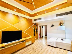 a living room with a flat screen tv on a wall at La Vista Home Stay with Parking in Ajman 