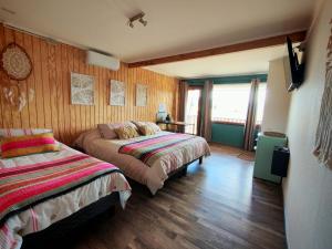 Ένα ή περισσότερα κρεβάτια σε δωμάτιο στο Tranquilo Austral