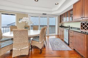 a kitchen with a table and chairs with a view of the ocean at Shiphouse 3 - Third Floor in Saint Simons