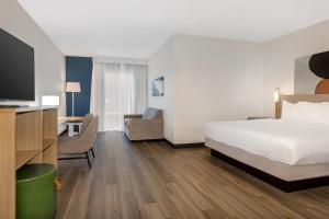 a hotel room with a bed and a desk and a tv at Spark By Hilton Montreal Midtown in Montreal +22 photos