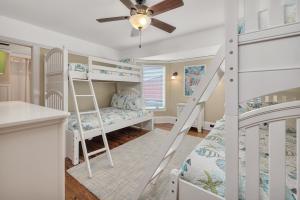 a bedroom with bunk beds and a ceiling fan at Shiphouse 3 - Third Floor in Saint Simons +61 photos