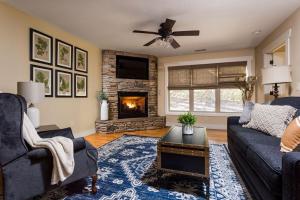 a living room with a couch and a fireplace at The Maple Cottage in Asheville