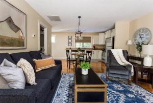 a living room with a blue couch and a kitchen at The Maple Cottage in Asheville +26 photos