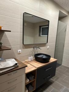 a bathroom with a black sink and a mirror at Haus Levi in Imst +11 photos