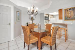 a dining room and kitchen with a table and chairs at Beach Club #107 in Saint Simons Island