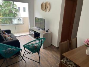 a living room with a couch and a tv at Decoradinho RJ in Rio de Janeiro