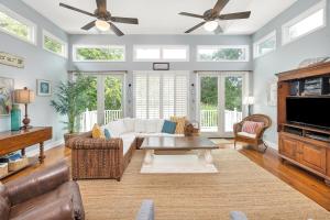 a living room with a couch and a table at 26 Coast - Shellbar Cottage in East End