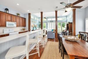 a kitchen and dining room with a table and chairs at 26 Coast - Shellbar Cottage in East End