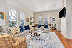 a living room with a couch and a table at 37 Coast - Ebb Tide Cottage in East End