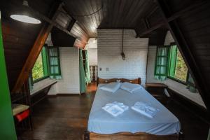 En eller flere senge i et værelse på Hotel Fazenda Bavária