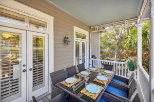 a table on the front porch of a house at 37 Coast - Ebb Tide Cottage in East End