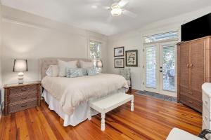 a bedroom with a bed and a ceiling fan at 37 Coast - Ebb Tide Cottage in East End +44 photos