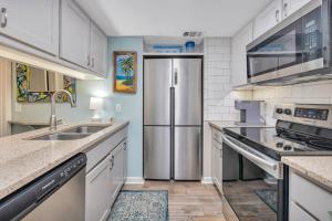 a kitchen with a stainless steel refrigerator at Shipwatch #106 in East End