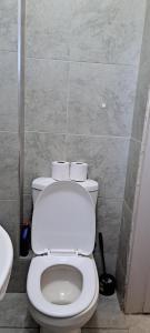 a bathroom with a white toilet and a sink at The cozy nook - Thindigua in Kiambu +35 photos