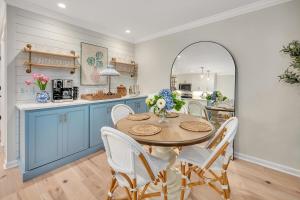 a kitchen with blue cabinets and a table and chairs at Demere Landing #162 in Saint Simons Island