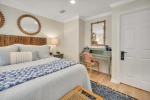 a bedroom with a bed and a desk and mirror at Demere Landing #162 in Saint Simons Island +30 photos