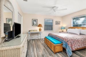 a bedroom with a bed and a flat screen tv at 1055 College in Saint Simons Island