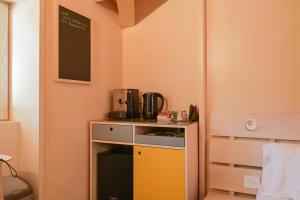 a small kitchen with a yellow and black appliance at La Presentosa guest house in Villalago +40 photos