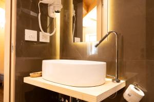 a bathroom with a white sink and a mirror at La Presentosa guest house in Villalago