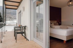 a bedroom with a bed and a balcony at Kronsun Percha in Perca