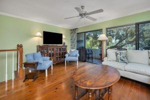 a living room with a couch and a table at 545 Beachview Dr in Saint Simons